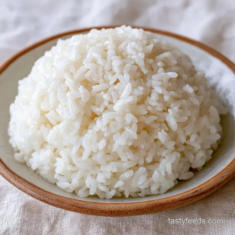 Pristine white grains piled high in a traditional wooden tub, reflecting soft light with a polished, sticky finish.